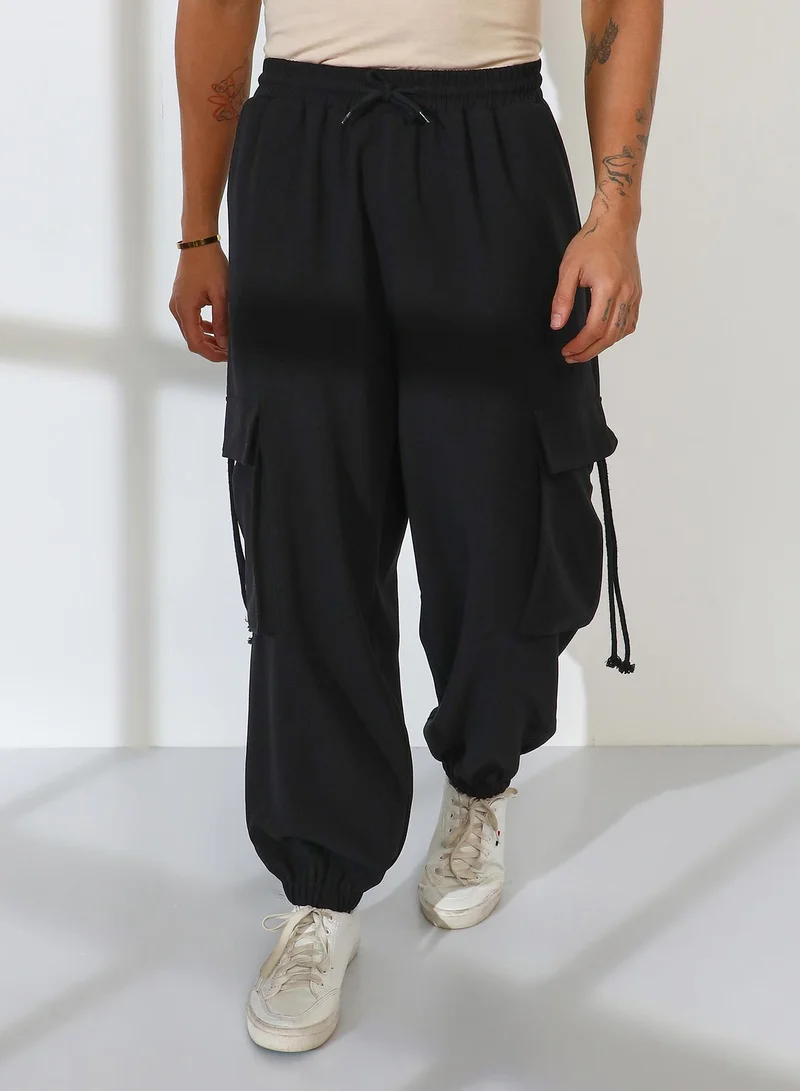 كامبوس سوترا Men's Charcoal Black Cuffed Baggy Utility Trousers For Casual Wear | Mid-Rise | 4 Pockets | Drawstring Closure | Cargo Pants Crafted With Comfort Fit For Everyday Wear